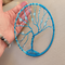 blue tree of life sits in palm of hand to show size lifelike